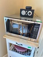 Front view of Panasonic stainless microwave on stand