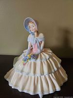 Front view of Royal Doulton Day Dreams figurine showing overall design and colours
