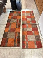 Runner and two mats laid out on tile floor