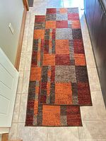 Two overlapping runner rugs showing full geometric pattern and colors