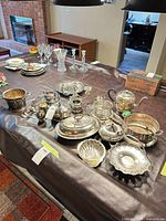 overview of assorted silverplate hollowware on table