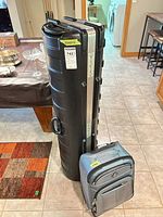 Atlantic suitcase and SKB golf carrier standing together