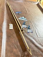 Full view of two curtain rods with finials and four blue ornaments