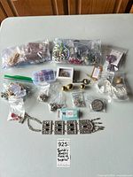 Overview of all bagged beads, findings, necklaces, cuffs and organizer on table