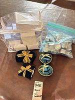 Group shot showing acrylic stand, assorted boxes, zip bag of tins