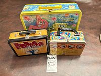 Group shot of three metal lunch boxes showing relative sizes and overall condition