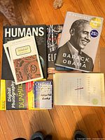 All eight books laid out on floor showing covers