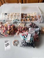 Overview of organizer and multiple bags of assorted beads and pendants