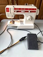Front view of Singer 9805C sewing machine with attached power cord and separate foot pedal