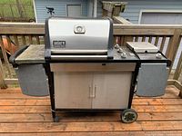 Front view of Weber Genesis Gold grill on deck