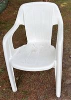 Front view of a white plastic patio armchair