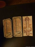 Obverse of three Canadian $2 bills