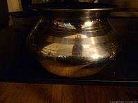 side profile showing rounded body and flared rim