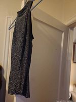 Side view of glitter top on hanger