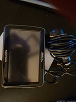 Front view of Magellan RoadMate GPS and coiled power cable
