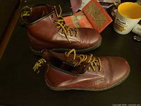 Side view of both burgundy Dr. Martens boots showing overall condition