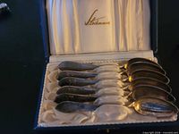 open case showing six Stockmann silver spoons and satin interior logo