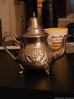 Overall view of silver plated teapot showing design and form