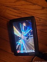 Front view of TomTom GPS displaying startup screen