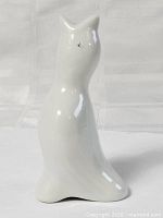 Front view of glossy white ceramic bird pie funnel standing upright