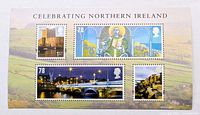 Front of unused Royal Mail Celebrating Northern Ireland miniature stamp sheet showing four stamps and scenic backdrop