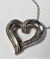 Heart pendant front view showing design and pavé accents