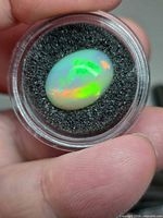 Front view of oval opal showing multicolour play-of-colour
