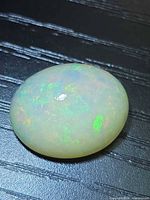 Front view of oval opal showing play of colour