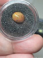 Gemstone in gem jar showing overall appearance and colour play