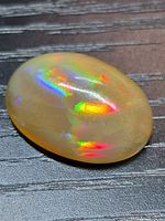 Top view showing oval cabochon and rainbow play-of-color