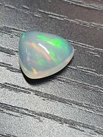 Top view showing trillion cabochon opal with play-of-color