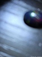 Blurry overview of the opal cabochon on dark surface