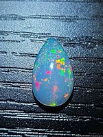 Front view of pear-cut opal showing play-of-color