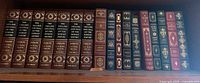 Entire row of 17 leatherette books on shelf