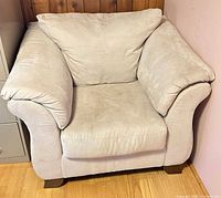 Front view of beige microfiber rolled-arm accent chair