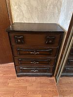 Front view of four-drawer dark brown veneer dresser