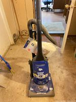 Full view of vacuum cleaner with hose, wand and bag pack