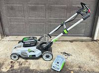 Full mower with battery installed, charger beside