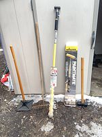 Group shot of all five items standing against shed