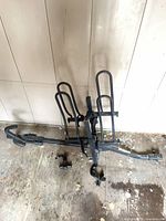 Full view of hitch-mounted bike rack on floor