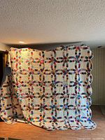 Full view of entire king size quilt draped to show pattern and scale