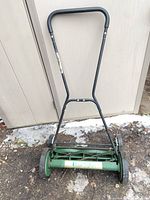 Full view of Lee Valley push reel mower standing upright