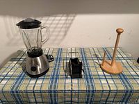 Blender, french fry cutter and wooden paper towel holder on table