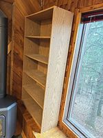Front view of light oak laminate bookcase showing five shelves