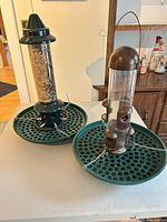 Both bird feeders side by side on table