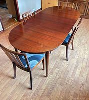 Top view of oval mahogany table with two chairs