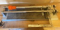 Top view of entire tile cutter showing rails, handle and base