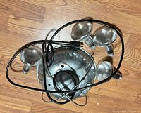 Fixture with cord and four reflector bulbs on floor