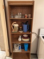 Full shelving unit with all kitchenware pieces visible