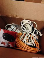 Overall lot in box showing cords, power strips and boxed heater